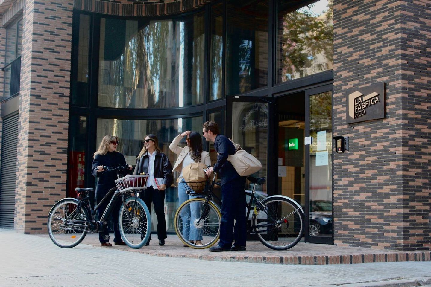People arriving at La Fabrica &Co, a coliving and coworking space in Barcelona.