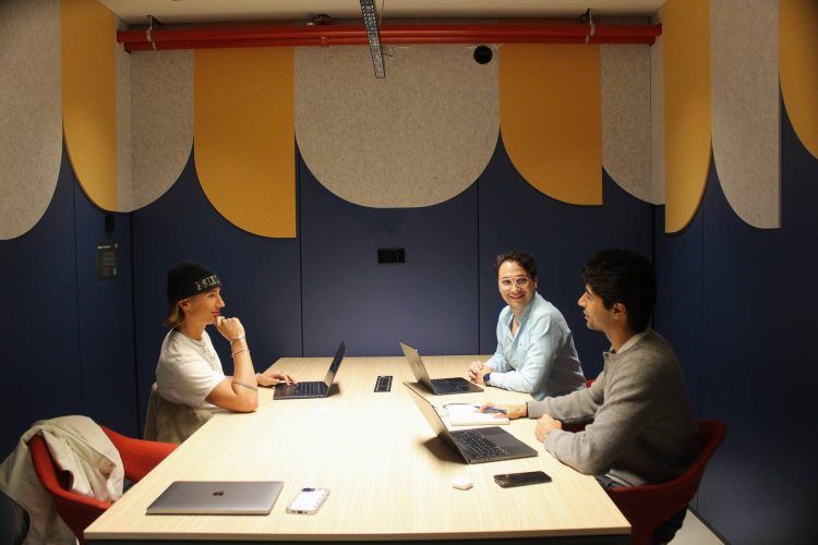 People meeting in a modern meeting room at La Fabrica &Co, a coworking space in Barcelona.